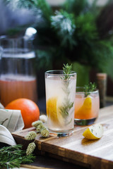 Pear and grapefruit compote with thyme and rosemary. Lemonade in a glass glass. Cooling drinks.