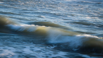 Image of crashing waves at sunset using a slow shutter speed