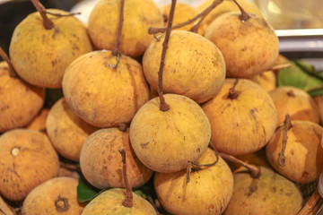 Lots of santol in basket at bazaar. agriculture farm full of organic vegetables. Pile of santol in the store. (selective focus)