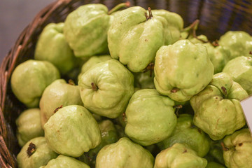 Lots of guava fruit at bazaar. agriculture farm full of organic vegetables. Pile of guavas in the store. (selective focus)