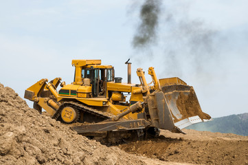 Bulldozer at a construction site changes its location