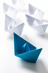 Blue and white paper boats. Concept of leadership boats for teamwork group or success