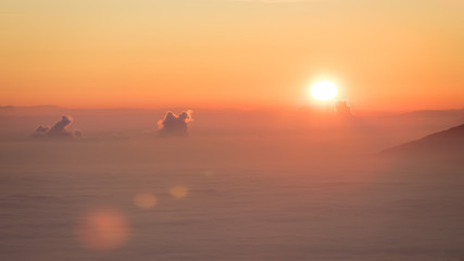 Sunset over the foggy valley covered by a smog (inversion weather)