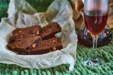 Black and strong morning coffee prepared an alternative method and homemade delicious, fresh pastries. Chocolate dessert with nuts, brownies on parchment.