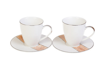 Two cups for tea or coffee on saucers, isolated on white background.