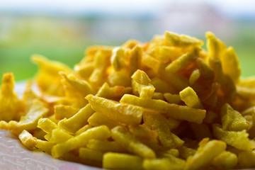 Freshly fried delicious French fries on a white plate