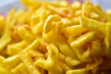 Freshly fried delicious French fries on a white plate