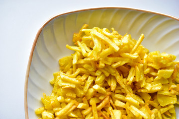 Freshly fried delicious French fries on a white plate