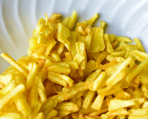 Freshly fried delicious French fries on a white plate