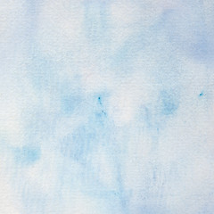 Blue watercolor background, handpainted in soft shades of ivory and blue with a few paint splots.
