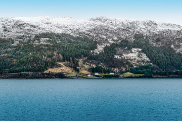 Fototapeta na wymiar Snowy mountains along the coastline of Norway, Scandinavia.