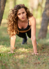 young woman doing stretching exercises in the park