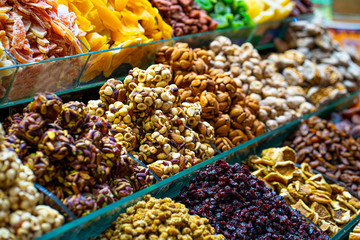Various bright colored turkish delights sweets and dried fruits vegetables on market in Istanbul,...