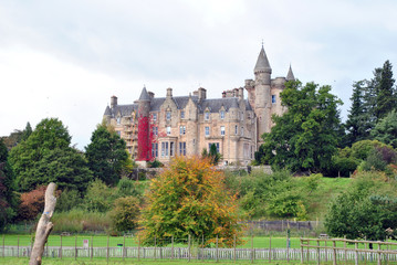 Obraz premium Old Scottish Country House under Repair surrounded by Woodland 