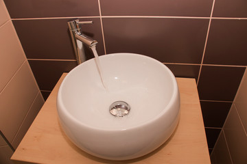 ceramic sink under the faucet. The concept of a healthy lifestyle, hygiene