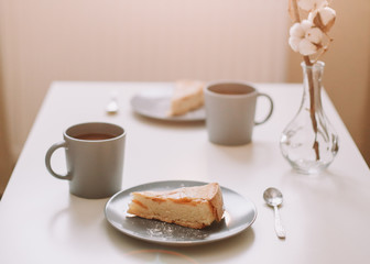 Piece of apple pie on plate with cup of coffee. Breakfast with coffee and cake in cafe. Food photography Table top photo