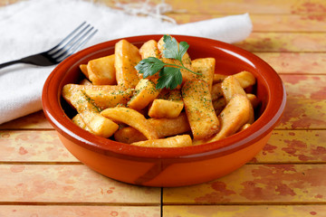fried potatoes with salt, parsley and rosemary