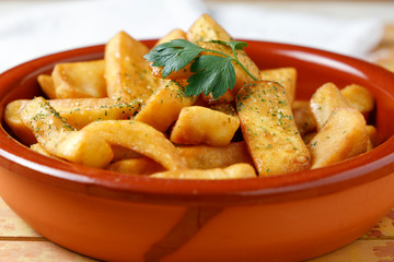 fried potatoes with salt, parsley and rosemary