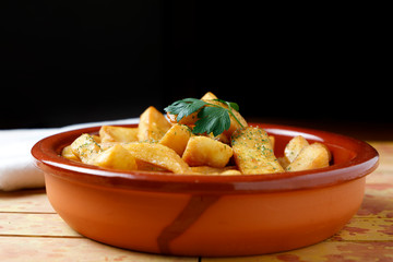 fried potatoes with salt, parsley and rosemary