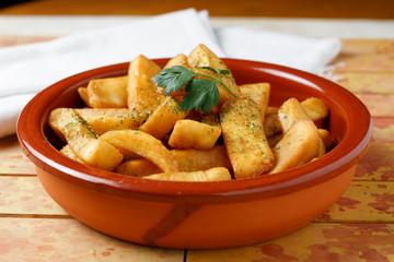 fried potatoes with salt, parsley and rosemary