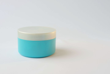 one blue cream jar with a gray lid on a white background