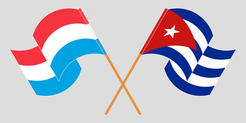 Crossed and waving flags of Luxembourg and Cuba