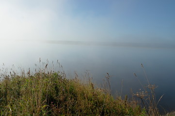 early morning, fog over the river. View from the high Bank