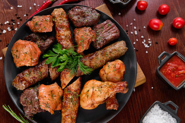 Assorted delicious grilled meat with vegetable. Mixed grilled bbq meat with vegetables. Set of...