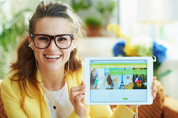 happy woman with headphones showing learn site