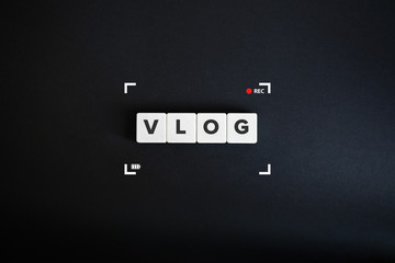 VLOG or Vlogging Banner. Video Content Marketing Concept. Block letters on the black paper background. Minimal aesthetics.