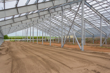 Fototapeta premium Construction steel frame of the new duilding. Construction of the main frame of the building. Agricultural buildings