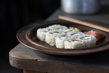 sushi on a brown plate