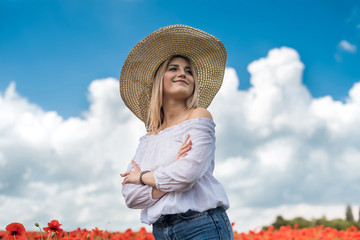 Ukrainian lady walking along a poppy field, the concept of sensuality, lifestyle