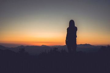 Fototapeta na wymiar silhouette of a woman in the mountains
