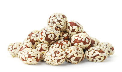 Chocolate covered peanuts and sesame seeds on a white background. Isolated