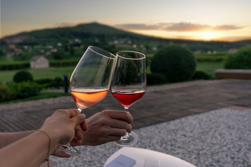 toast with an romantic view in Villany Hungary with Szarsomlyo hill and sunset