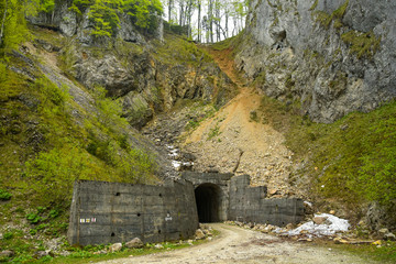 A tunnel crossing a steep cliff in Capatanii Mountains, Romania