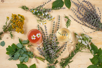 Autumn flower arrangement with useful wild herbs and herbal tea, top view, flat lay, selective focus