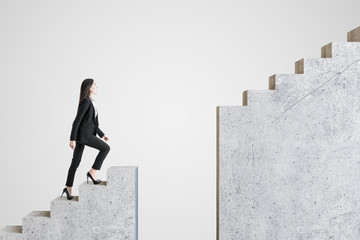 Businesswoman walking on intermittent concrete staircase