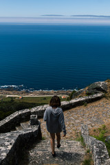 Fototapeta premium Attractive young female going down the stairs of a Monastery in the north of Spain