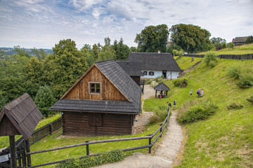 Fototapeta na wymiar historic wooden rural buildings with an open-air museum in Dobczyce Polish mountains on a summer day