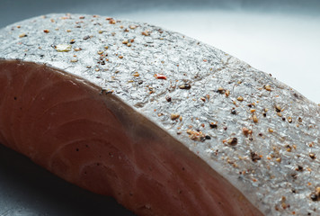 Raw salmon fillet on a plate, organic food.
