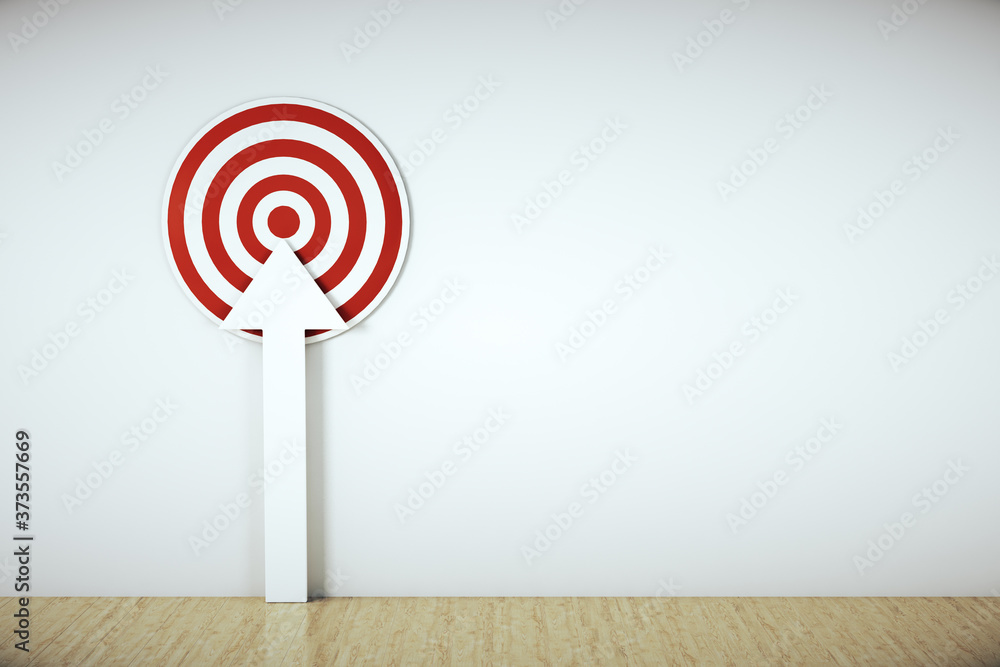 Poster red target with white arrow on wall.