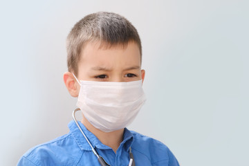 kid, boy playing doctor, face shield, health concept, disease treatment, coronavirus, COVID-19, life insurance, quarantine