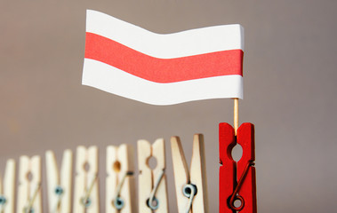 clothespins as illusion people banners with flag of Belarus protest patriotic background.	