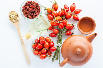 Dog rose, bunch branch Rosehips, types Rosa canina hips and herbal tea - Medicinal plants herbs composition