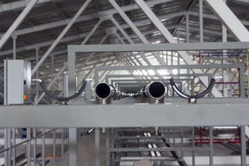 Installation of stainless steel pipes in a dairy. Milk pipes. Stainless steel pipes in the factory.