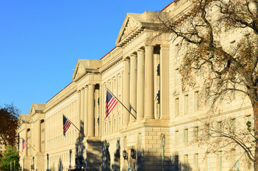 Washington DC, Department of Commerce Building with waving US flag
