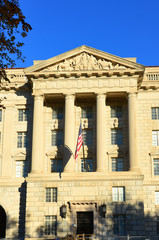 Fototapeta na wymiar Washington DC, Department of Commerce Building with waving US flag 