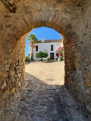 Archway into typical Spanish square, Castillo de Castellar August 2020